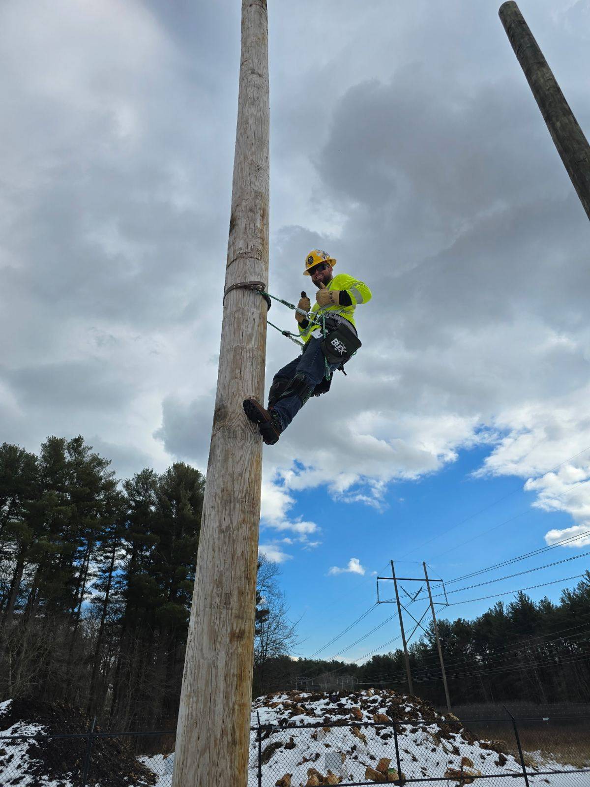 BC Line lineman climbing a pole